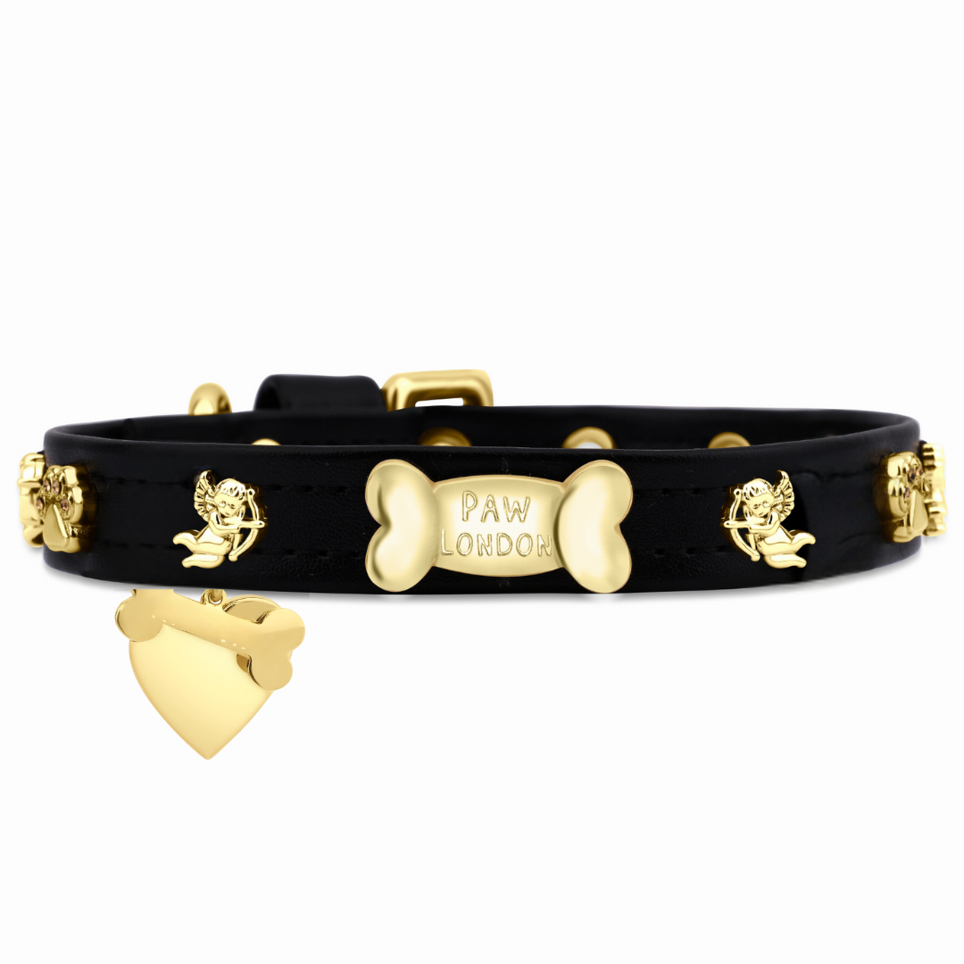 a black leather bracelet with a gold plated dog bone charm